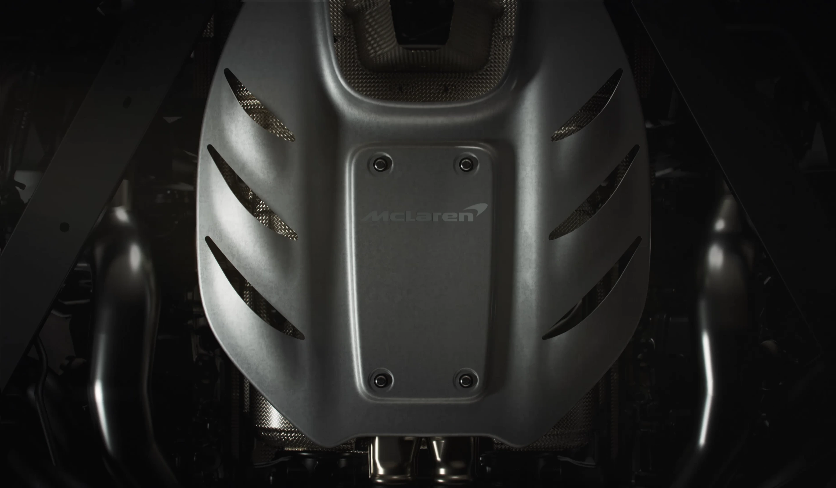 Detailed top-down shot of a matte grey McLaren engine plenum cover with ...