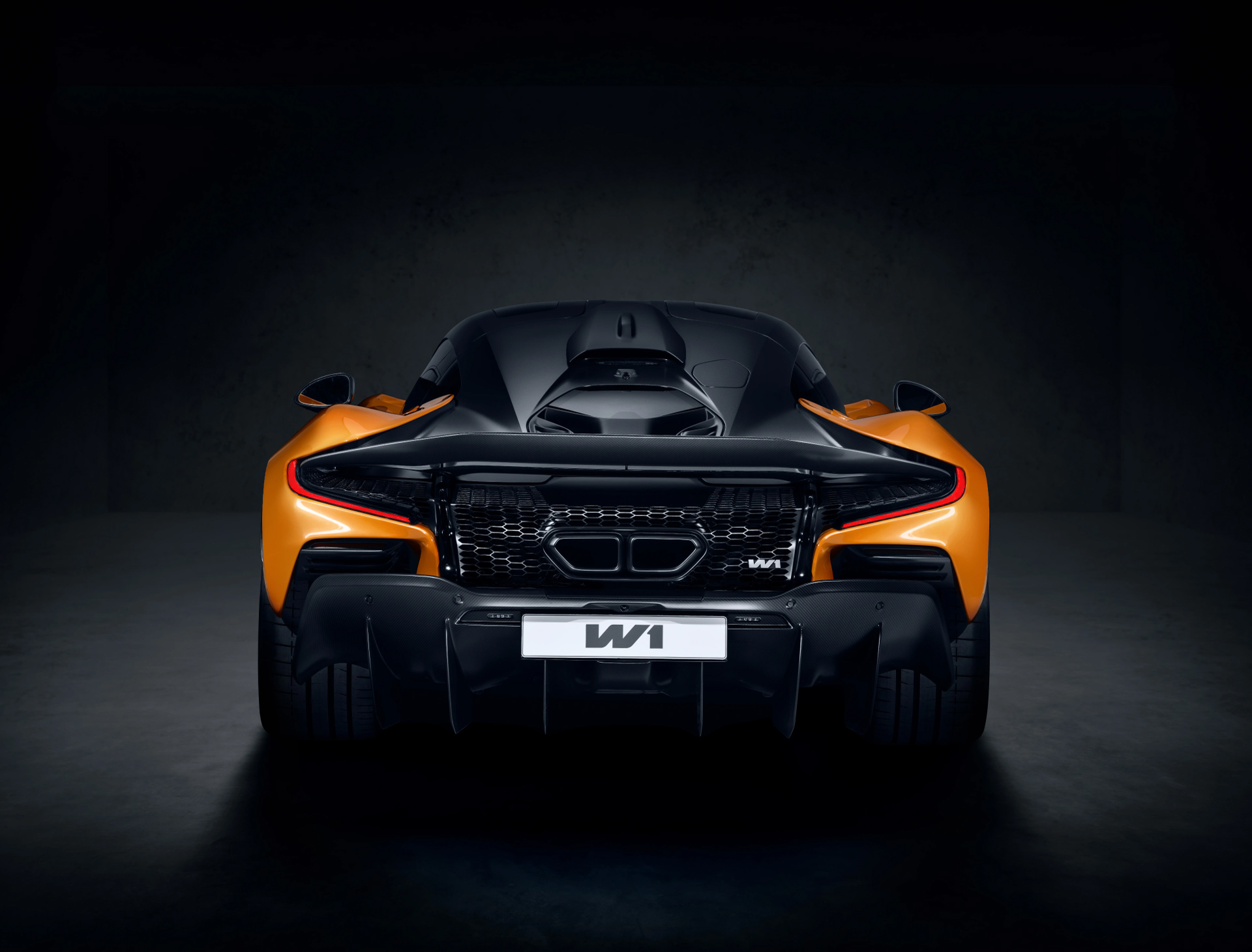 Rear view of an orange McLaren W1 in official studio photography